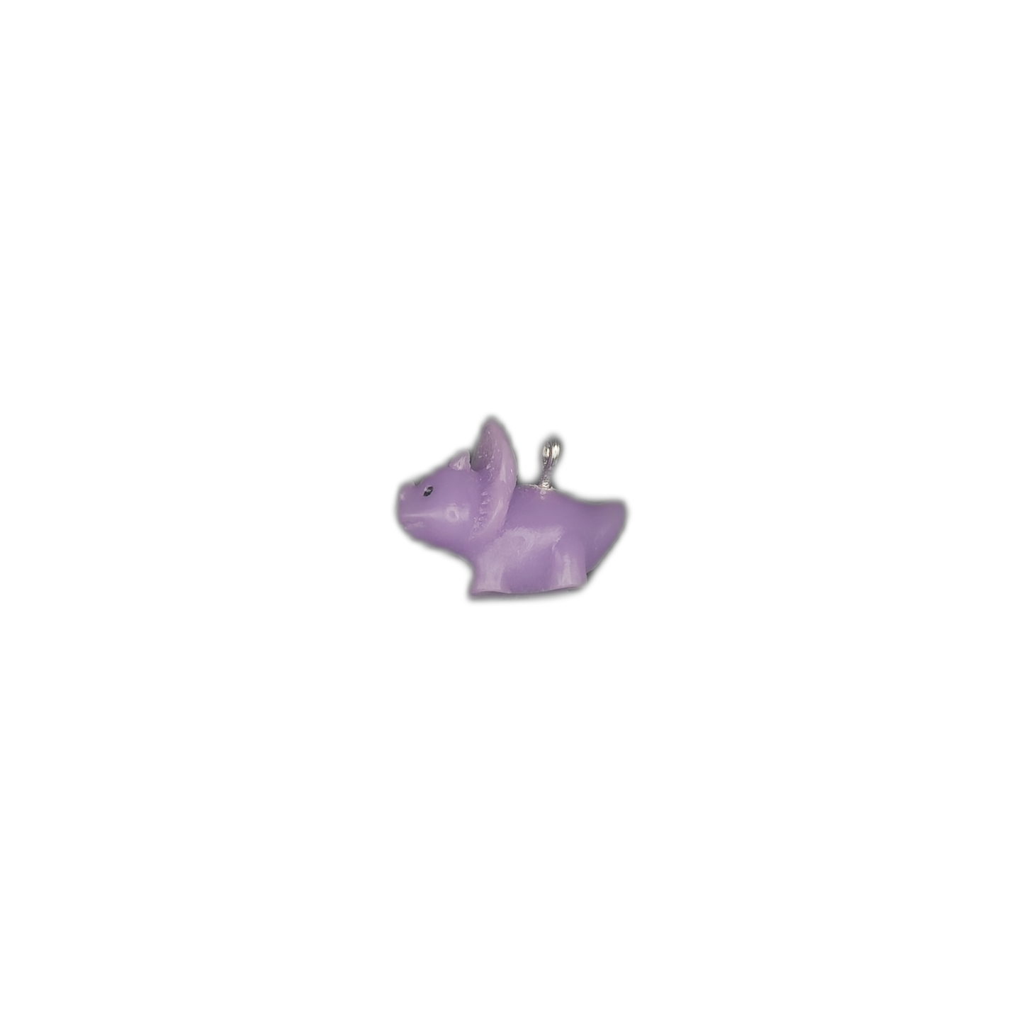 tiny purple dog charm centered on a black background