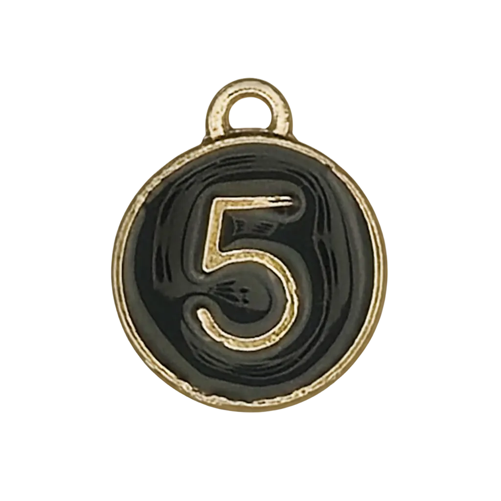 close-up of round black enamel charm with gold number 5