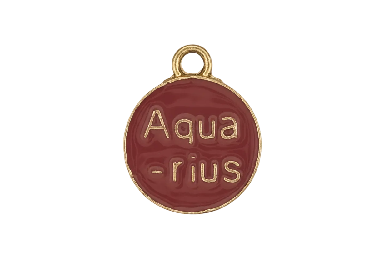 close-up of a small round red enamel charm with gold text reading “Aqua-rius.”