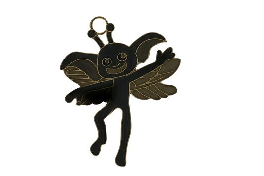 Close-up of a black and gold winged fairy charm with a smiling face.