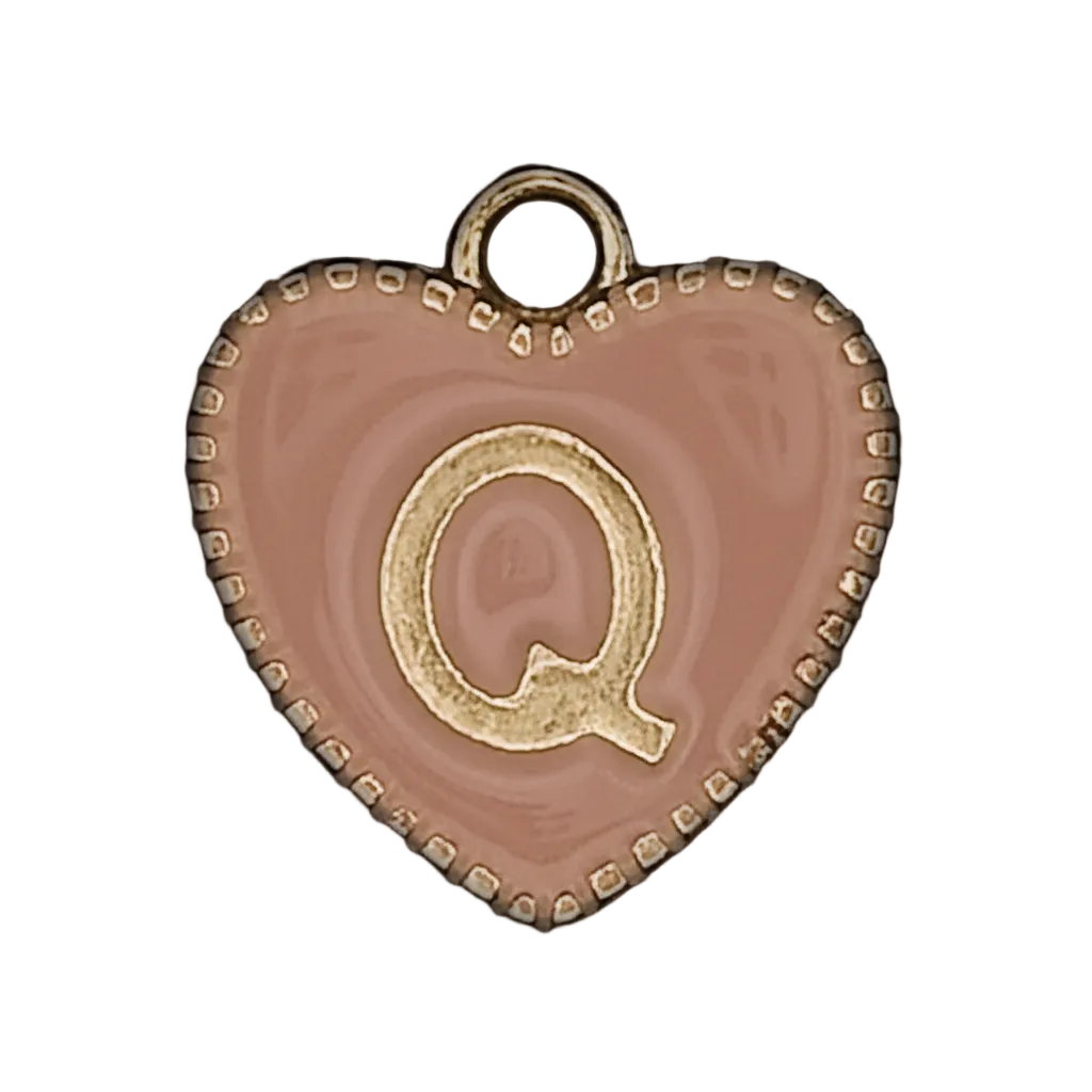 close-up of pink heart-shaped charm with gold letter Q