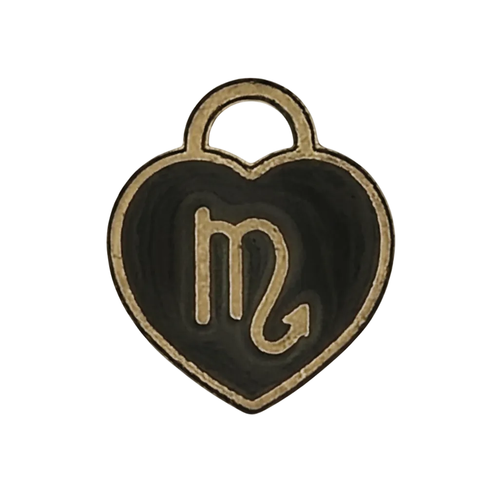 close-up of a black and gold heart-shaped charm with the scorpio glyph
