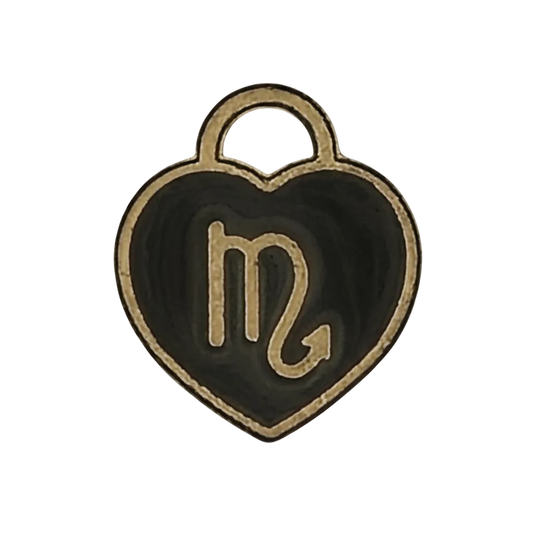 close-up of a black and gold heart-shaped charm with the scorpio glyph