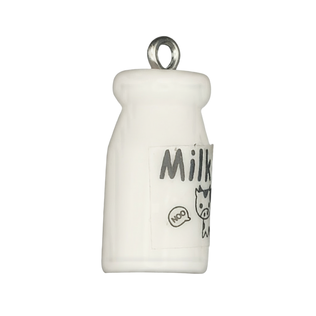 Close-up of a small white milk bottle charm with 'Milk' label and cartoon cow graphic.