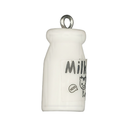 Close-up of a small white milk bottle charm with 'Milk' label and cartoon cow graphic.