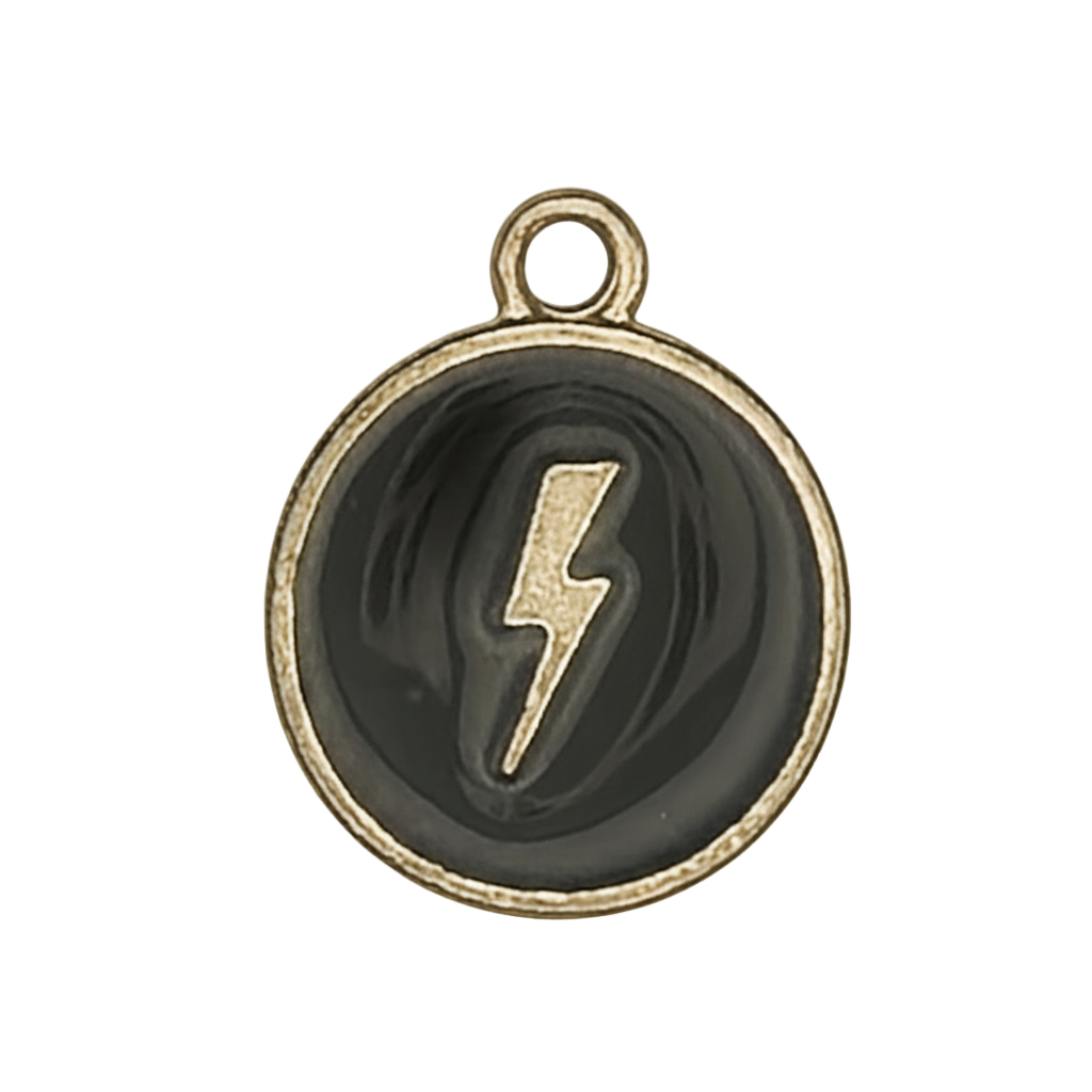 Close-up of a small round black-and-gold lightning bolt charm.