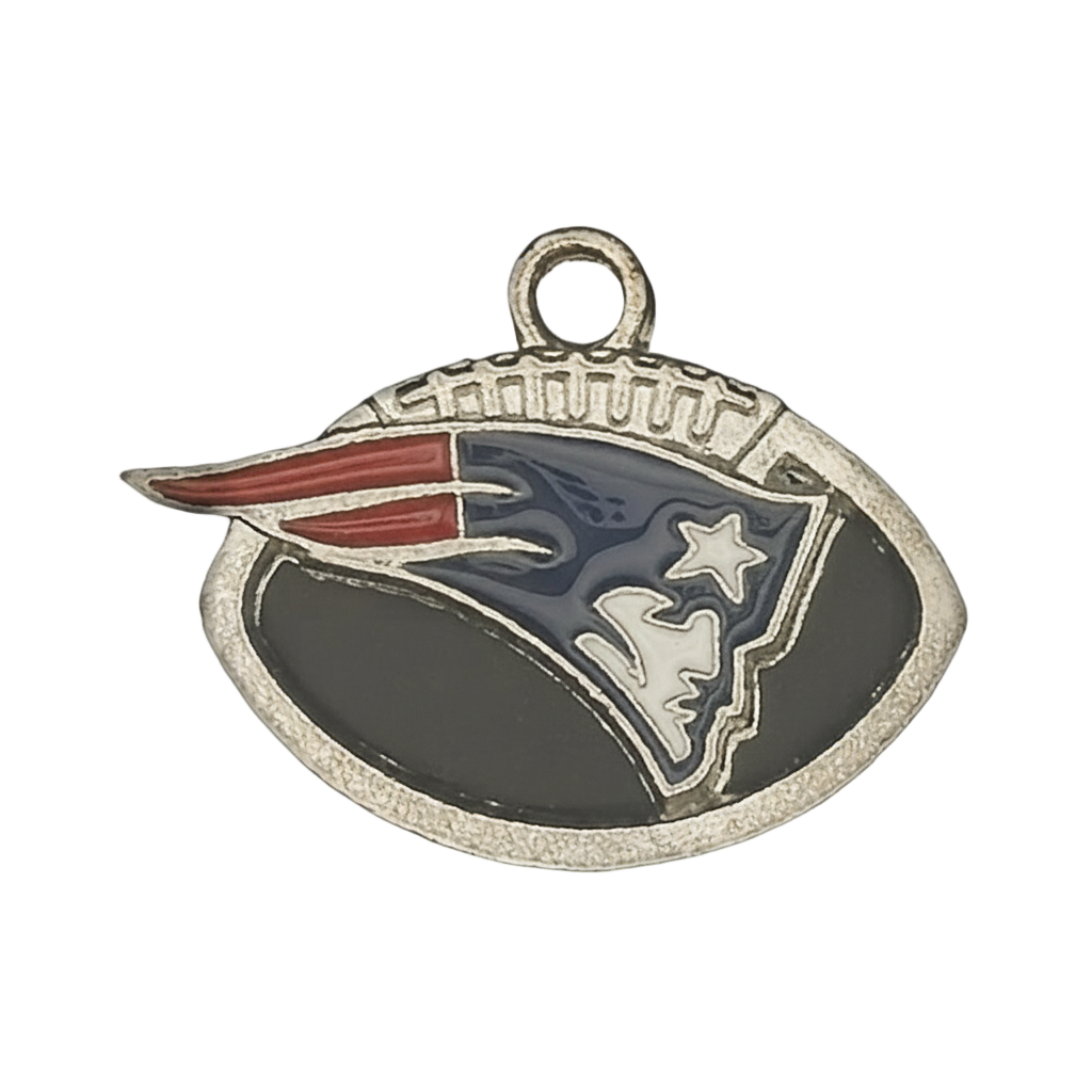 Close-up of football-shaped enamel charm with stylized profile and star in red, white, and blue on a black background.