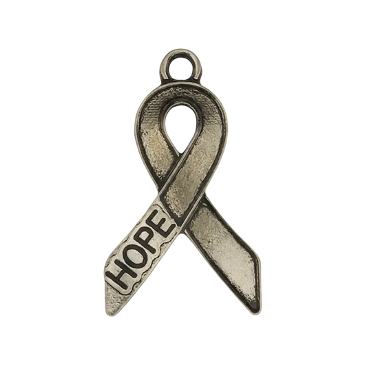 close-up of antique silver awareness ribbon charm with the word HOPE on a black background
