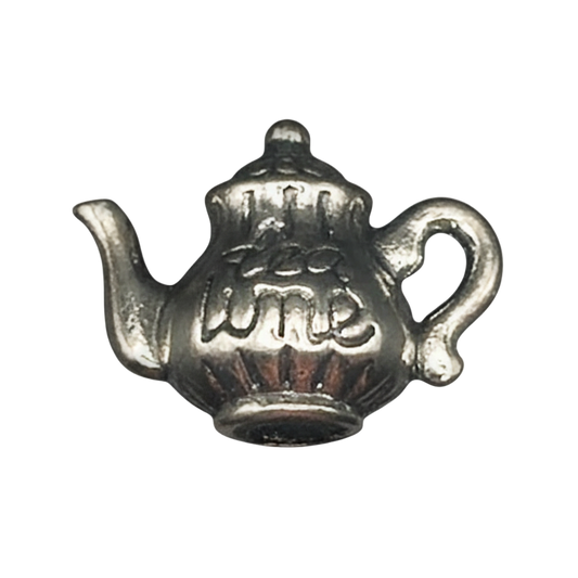close-up of a small silver teapot charm
