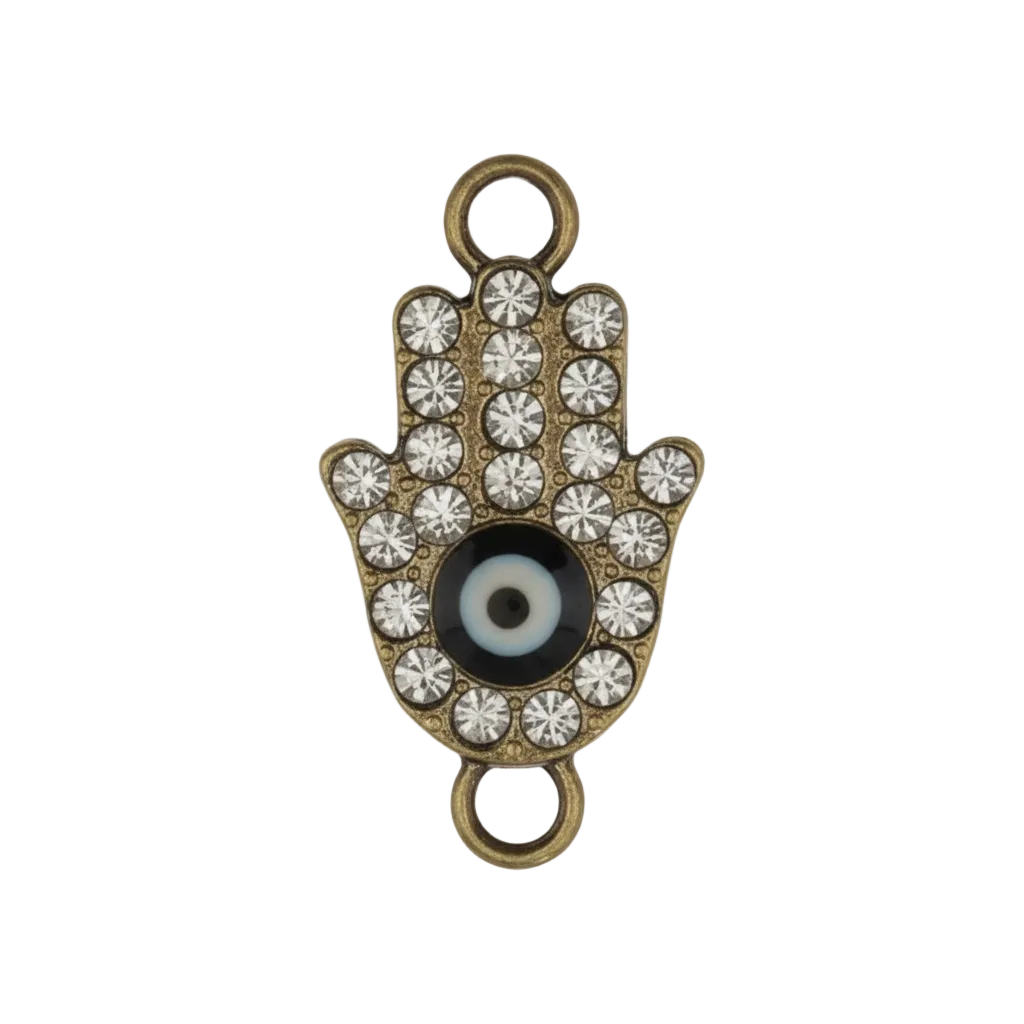 close-up gold-tone rhinestone hamsa hand charm with black-and-white eye on black background