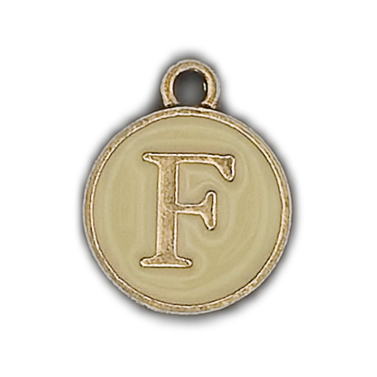 close-up of round gold and cream charm with letter F