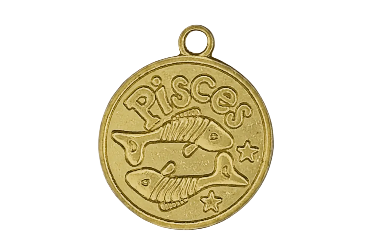 Close-up of a gold round Pisces zodiac charm with two fish and stars.