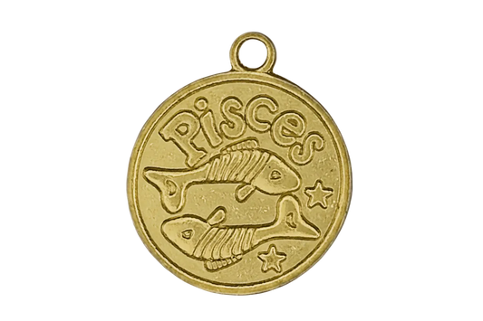 Close-up of a gold round Pisces zodiac charm with two fish and stars.