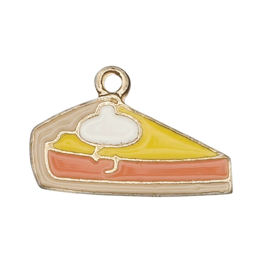 close-up of enamel pie slice charm with yellow and orange sections and a white dollop, gold-tone edge