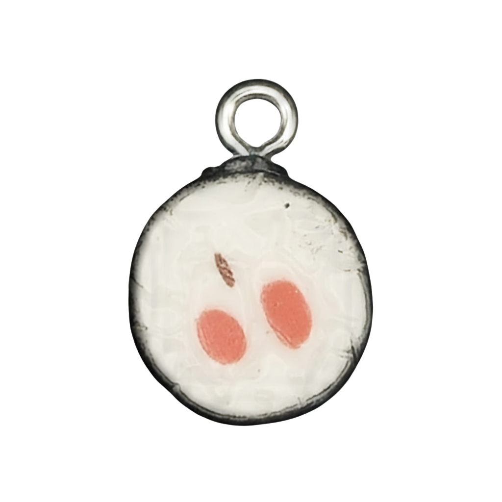 close-up round sushi roll charm with white rice center, two orange ovals, and black rim on black background