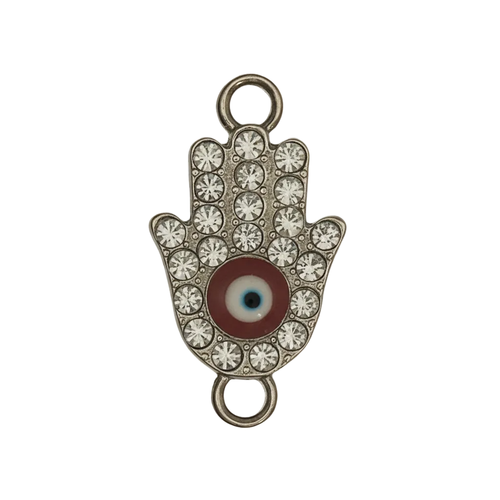 close-up of a rhinestone Hamsa hand charm with a red evil eye center on a black background