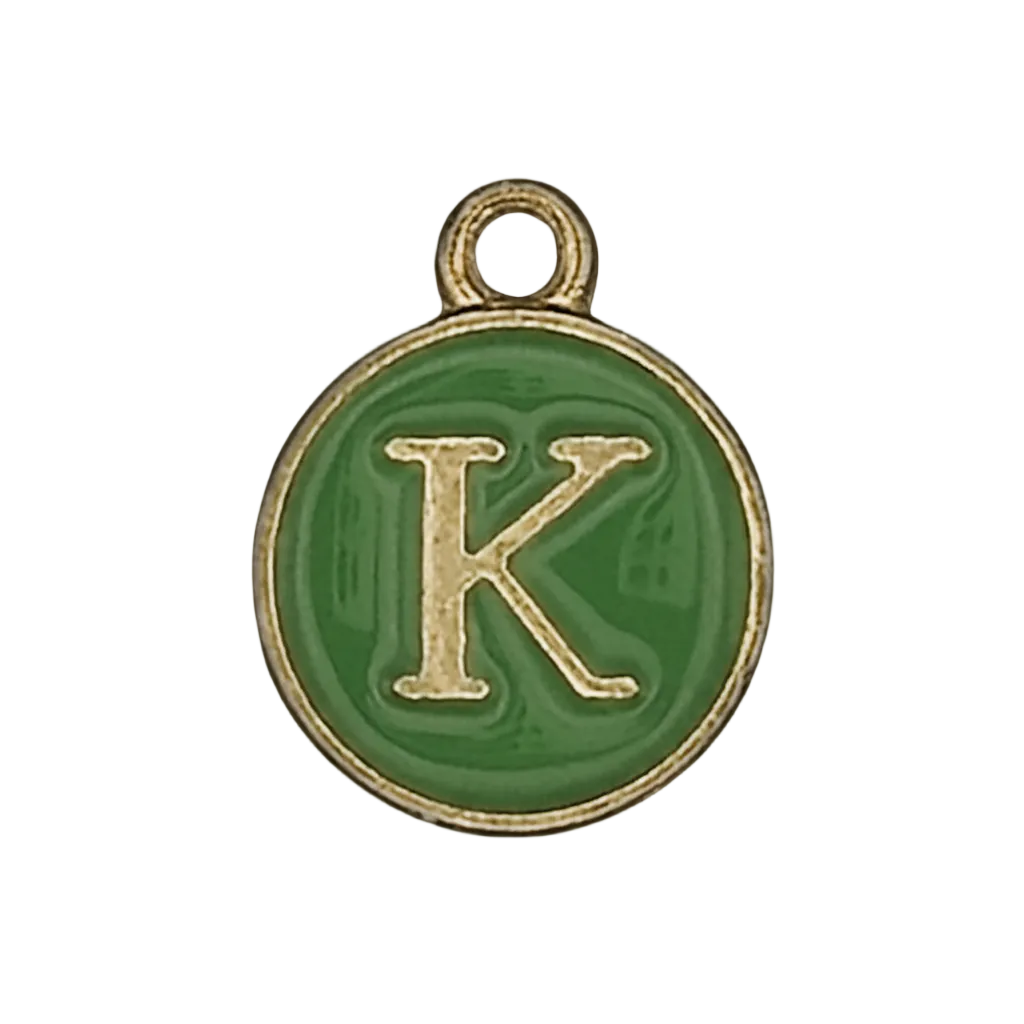 close-up of round green enamel charm with gold letter K