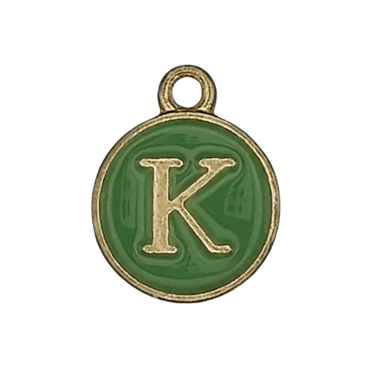 close-up of round green enamel charm with gold letter K