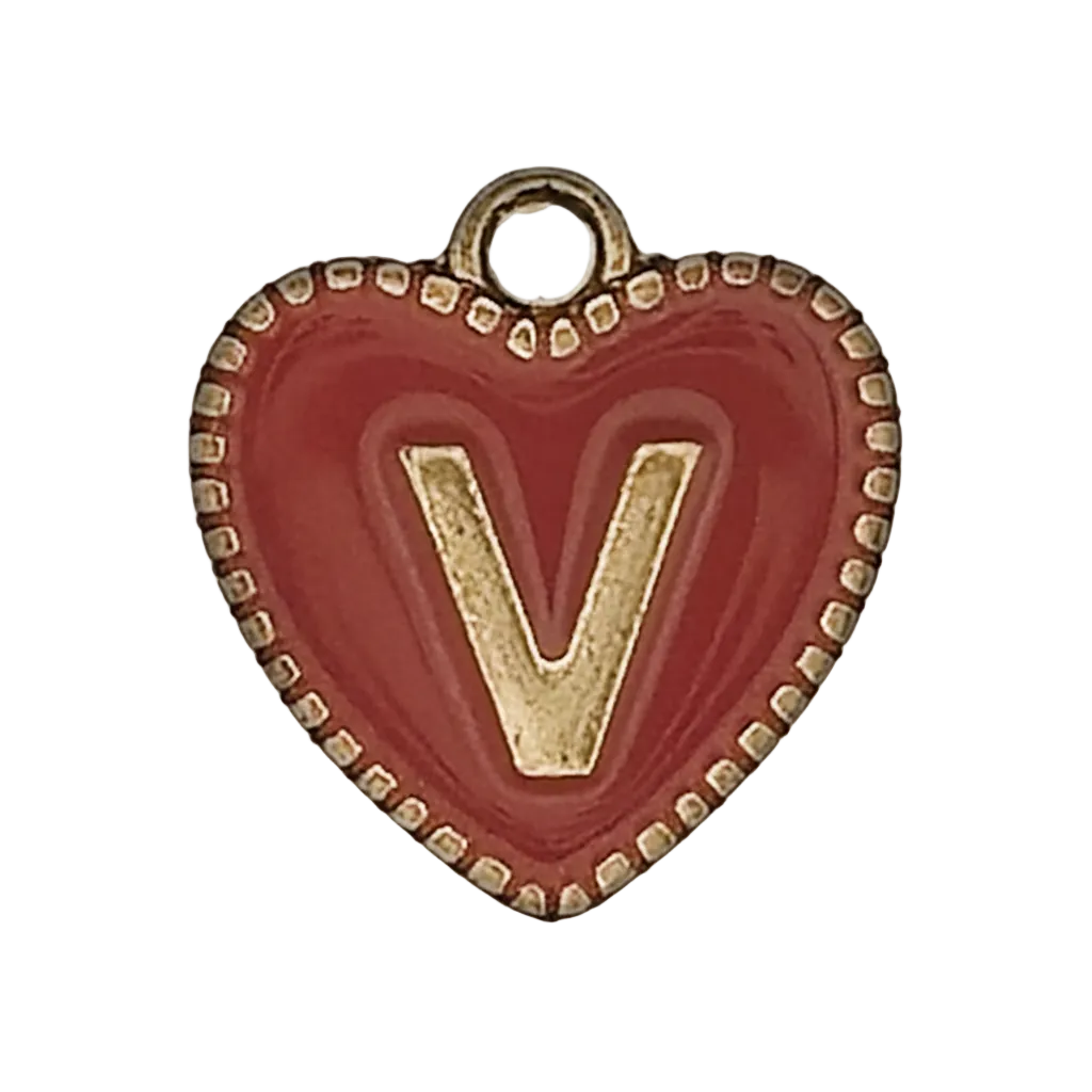 close-up of red heart charm with gold letter V and dotted edge
