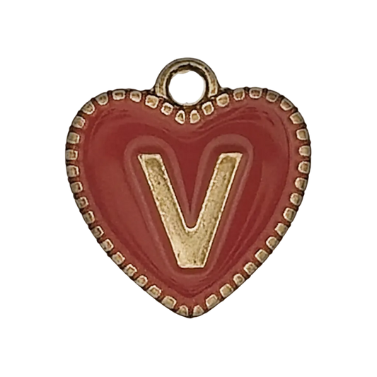 close-up of red heart charm with gold letter V and dotted edge