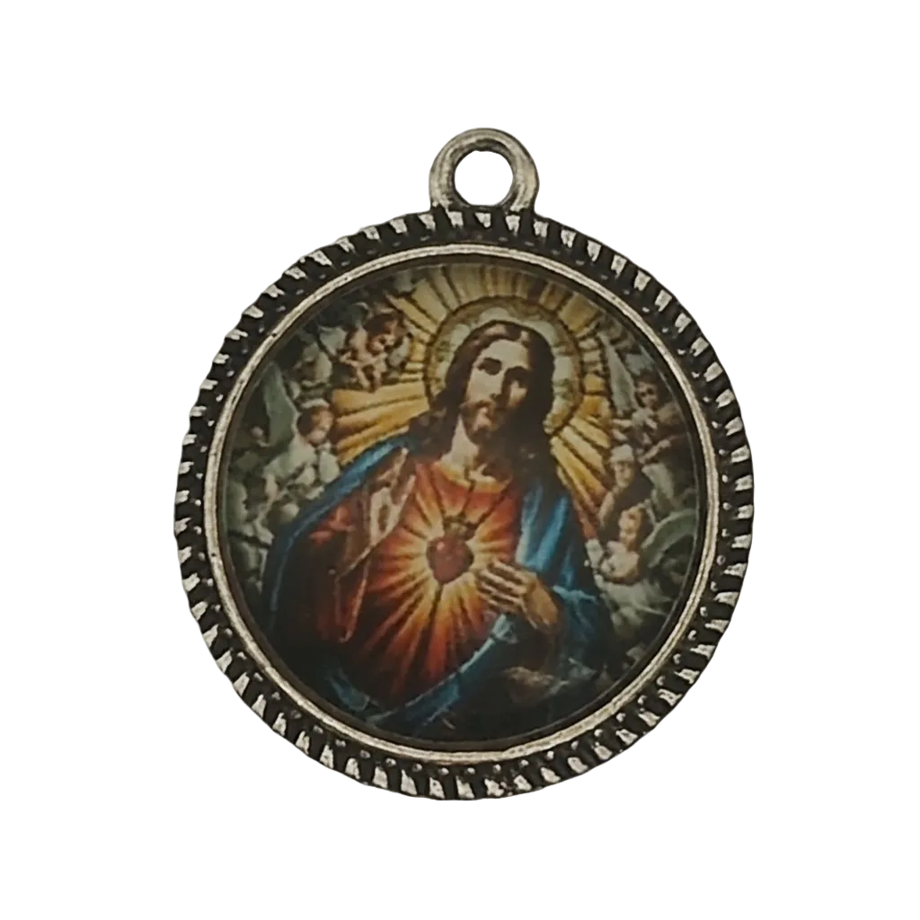 close-up of round charm with sacred heart icon and beaded edge on black background