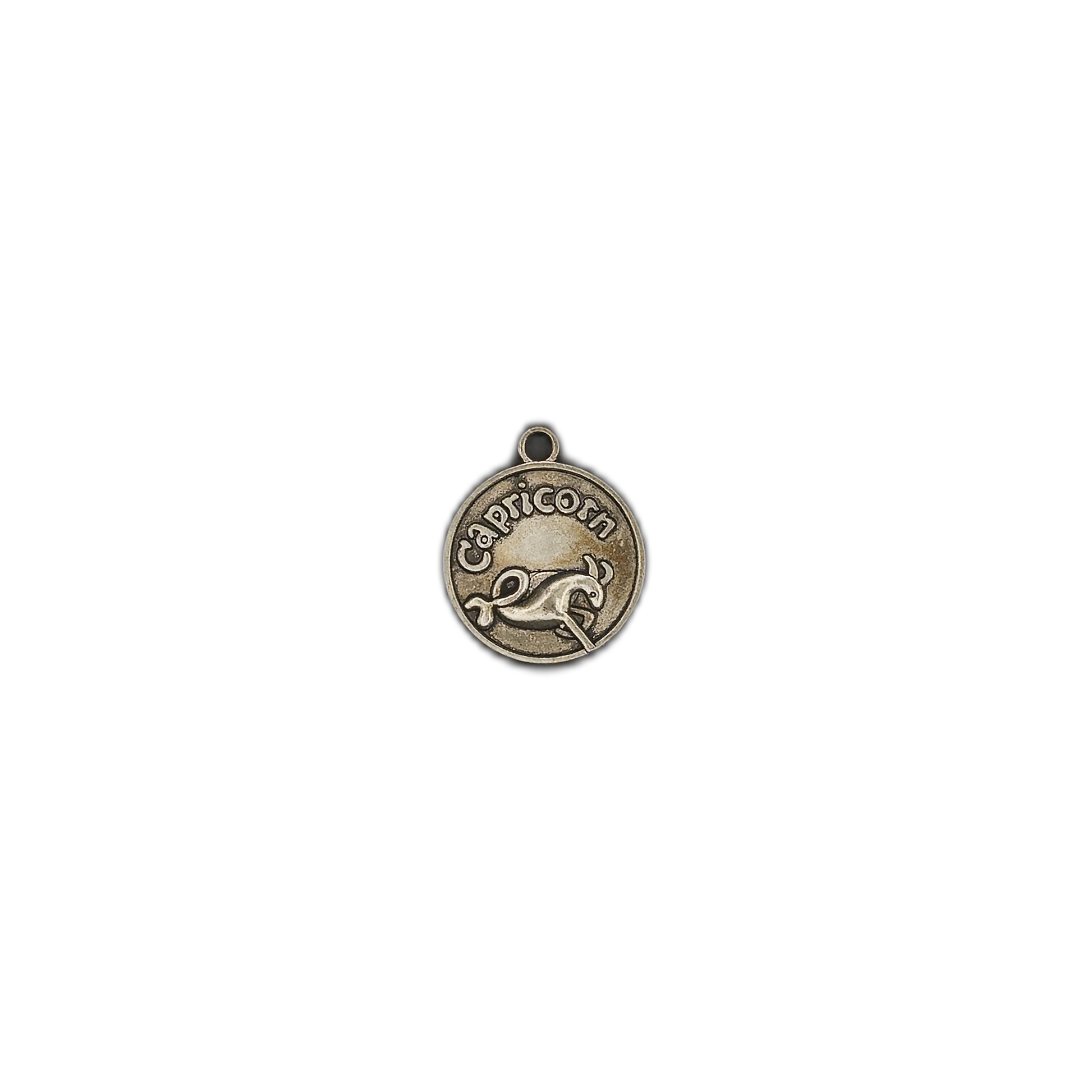 Small round bronze Capricorn zodiac charm on a black background.