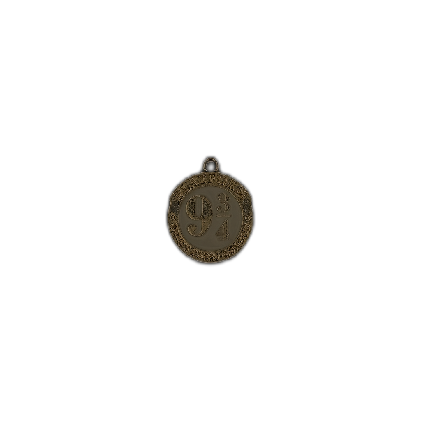 small round gold-tone Platform 9 3/4 charm on a black background