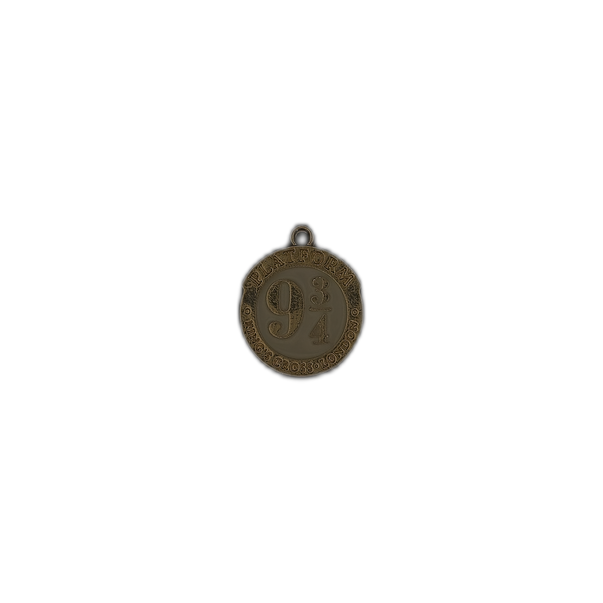 small round gold-tone Platform 9 3/4 charm on a black background