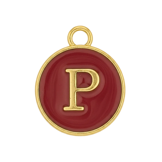 Close-up of round red enamel charm with gold letter P