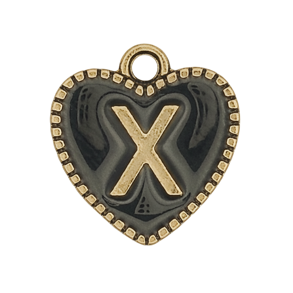 close-up of a heart-shaped charm with a raised gold letter X and dotted border on a dark background