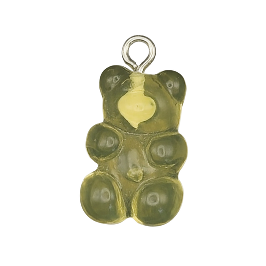 close-up of translucent green gummy bear charm on black background