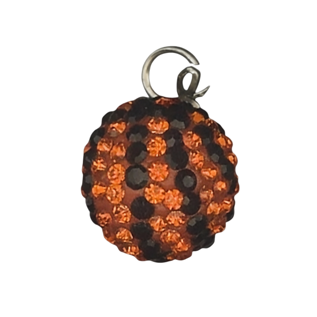close-up of round orange and black pavé crystal ball charm on black background