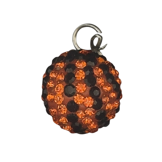 close-up of round orange and black pavé crystal ball charm on black background