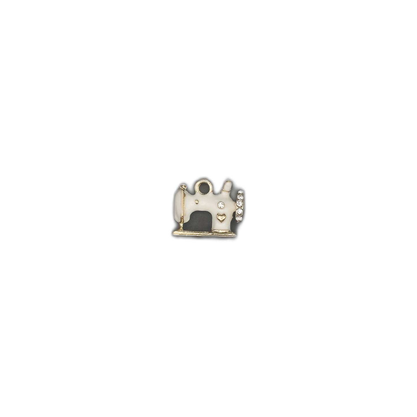 small white enamel sewing machine charm centered on a black background