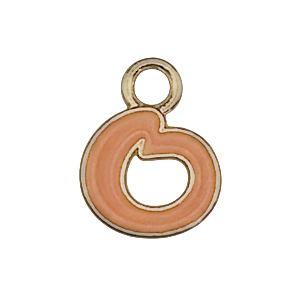 close-up of a peach enamel swirl charm with a gold outline on a black background