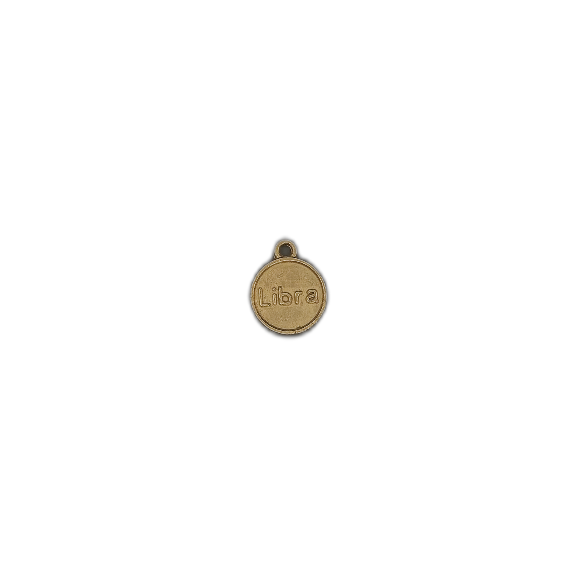 small round gold-tone Libra charm on black background
