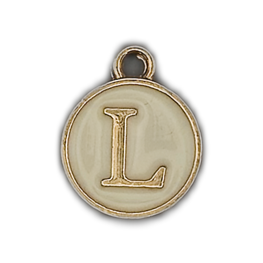 close-up of round gold-tone charm with raised letter L on ivory enamel