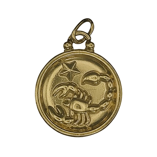 close-up of gold round scorpio zodiac charm with star on black background