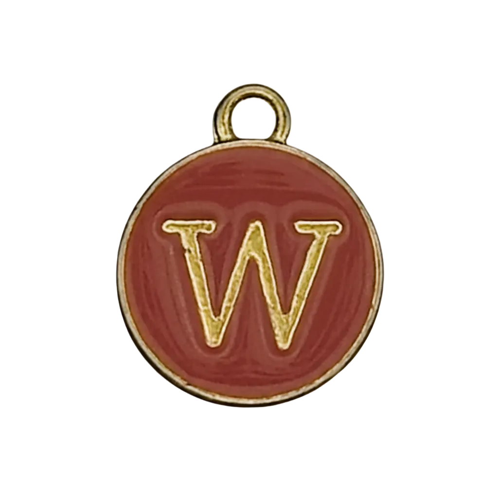 close-up of round red enamel charm with gold letter W