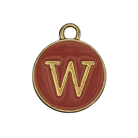 close-up of round red enamel charm with gold letter W