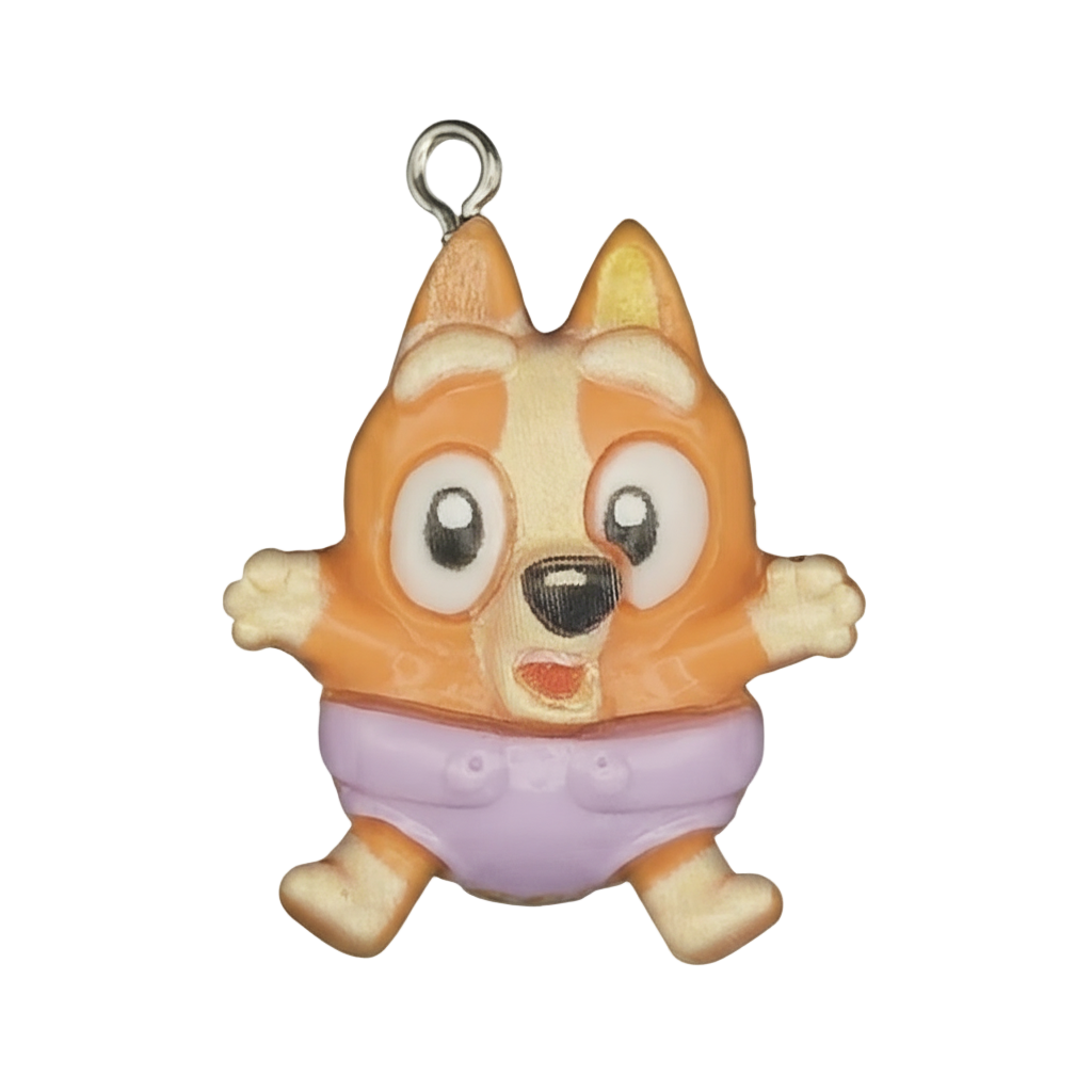 Close-up of orange cartoon puppy charm wearing a purple diaper on a black background.