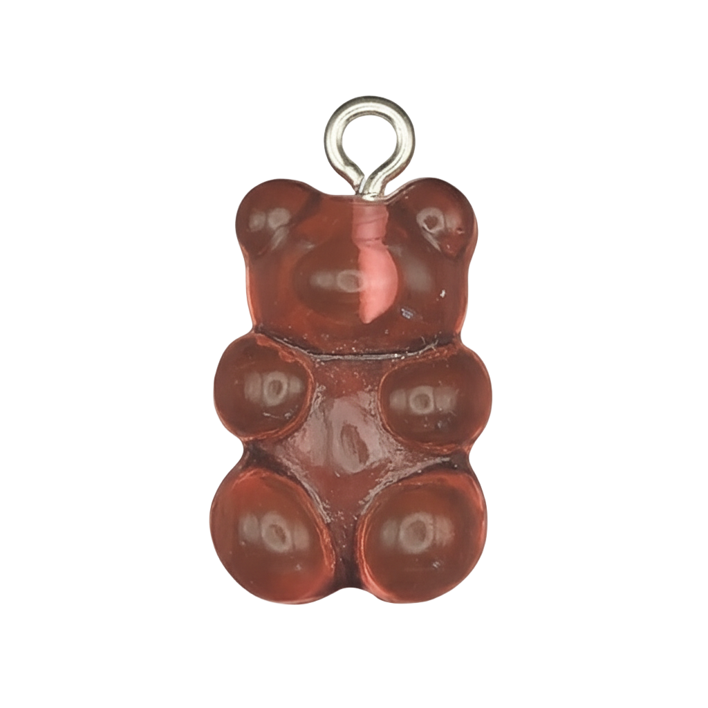 close-up of red gummy bear charm on black background
