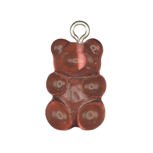 close-up of red gummy bear charm on black background