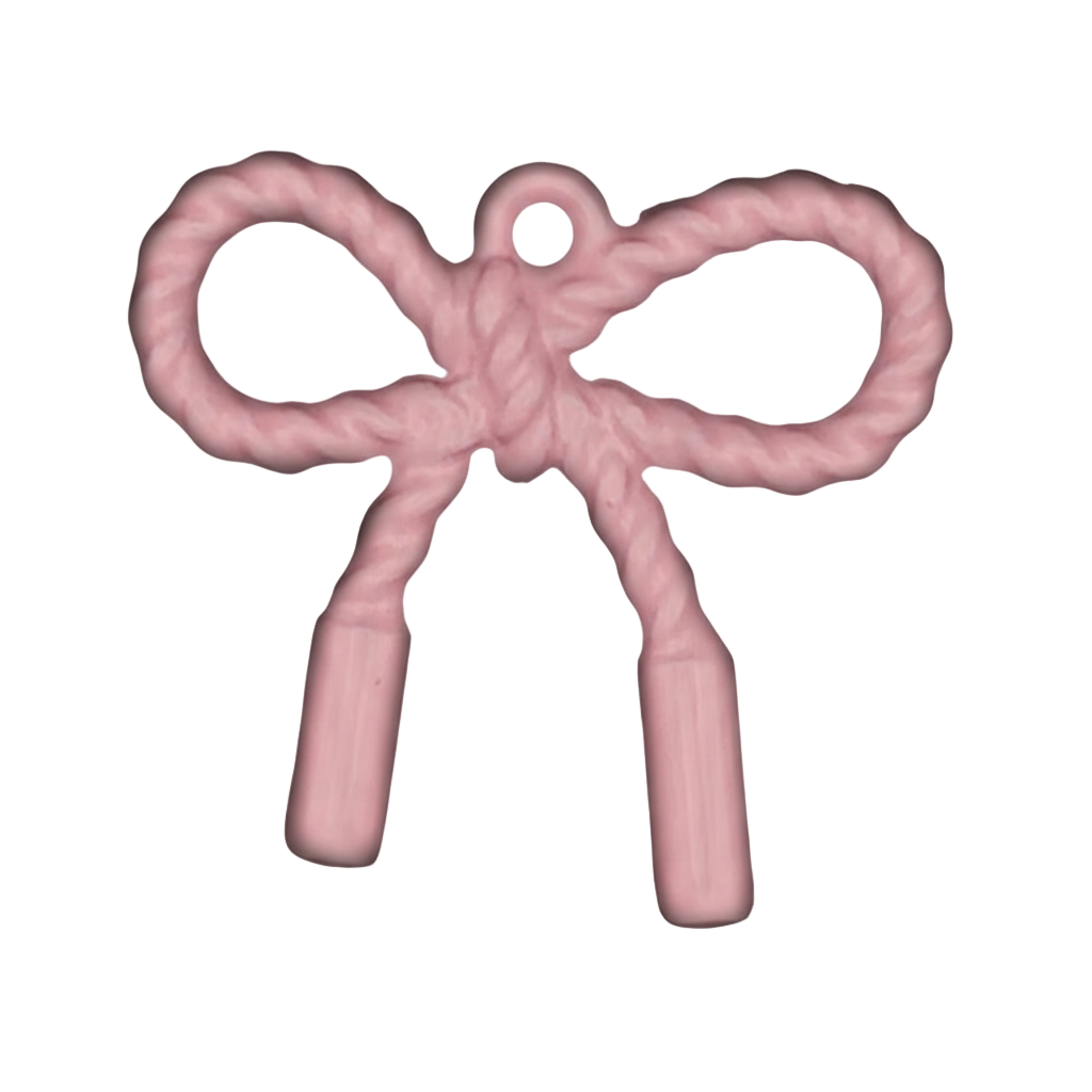 close-up of pink rope-textured bow charm on black background