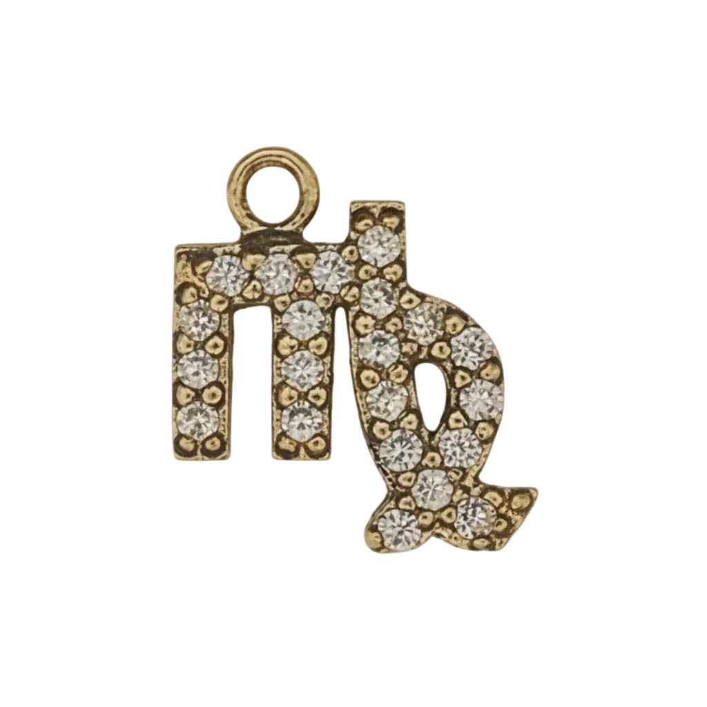 close-up of gold-tone pavé Virgo symbol charm on black background
