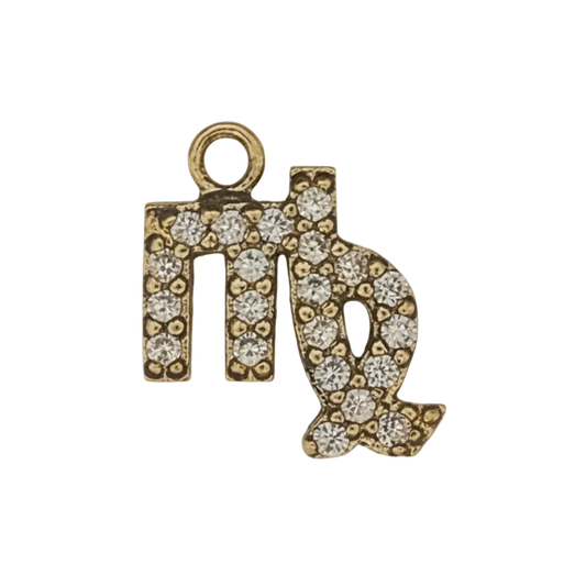 close-up of gold-tone pavé Virgo symbol charm on black background