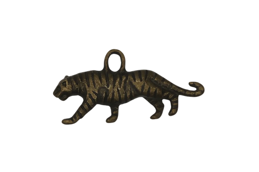 close-up of bronze tiger-shaped charm on black background