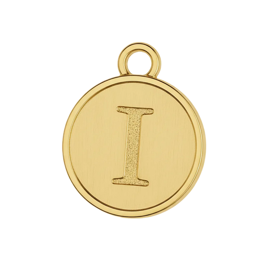 Close-up of round gold-tone charm with cream center and raised letter I.