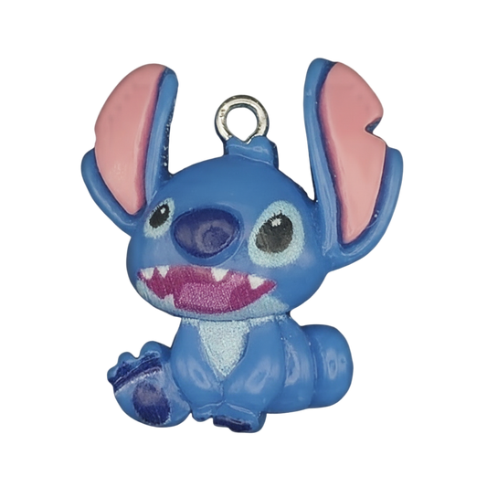 close-up of blue alien character enamel charm with big ears on black background