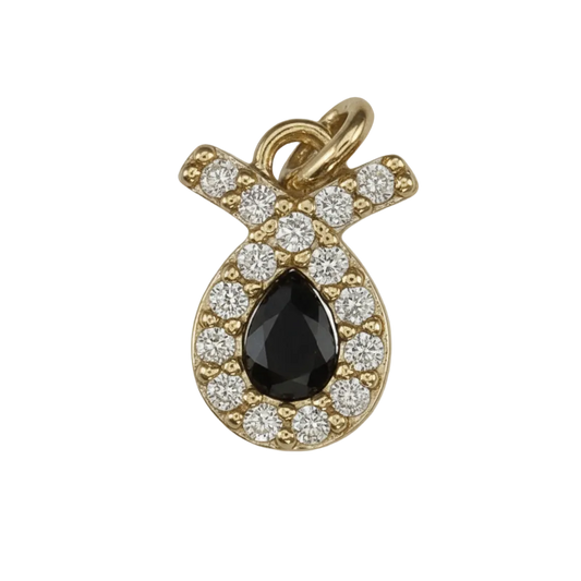 close-up of a small gold-tone pavé ribbon charm with clear stones on a black background